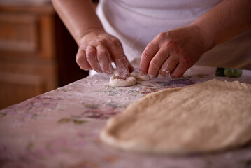Cook's hands kneading dough for cakes. Preparing the flour for leavening