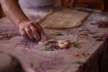 Cook's hands kneading dough for cakes. Preparing the flour for leavening