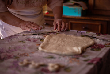 Cook's hands kneading dough for cakes. Preparing the flour for leavening