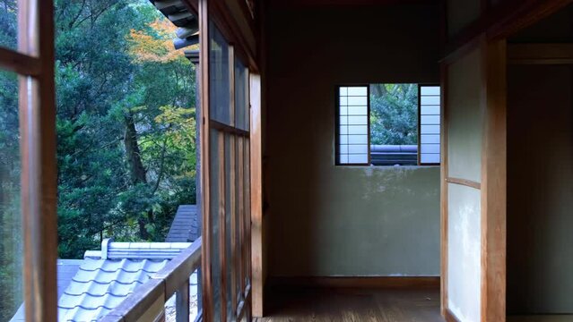 Traditional Japanese house hallway with tatami floor and shoji paper doors.