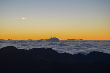 Sunrise Above the Clouds on Volcanic Landscape
