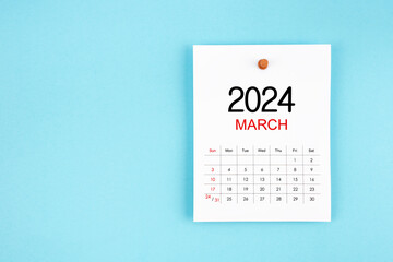 March 2024 calendar page with push pin on blue background.