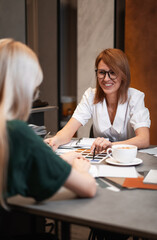 Close up hand choosing color from color sample swatch. The designer works with the customer and recommends the colors of decorative coatings.