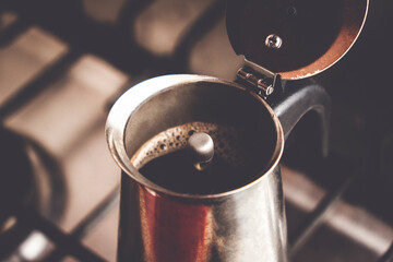 Preparing coffee in a geyser coffee maker.