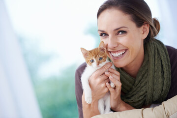 Happy, pet and portrait of woman with kitten in home for bonding, friendship and relax on sofa. Animal care, house and person with adorable, cute and young cat on couch for playing, embrace and love