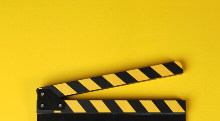 Yellow clapper board or movie slate on yellow background.