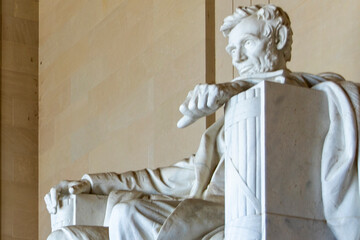 Sixteenth President Abraham Lincoln seated in his armchair, in a temple and pantheon on the National Mall in Washington DC, USA.