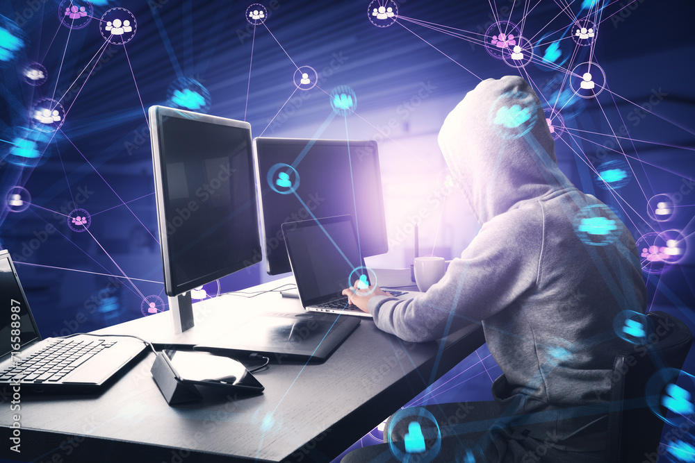 Aufkleber Side view of hacker in hoodie using computers at desk with connected digital people team icons on dark blurry purple office interior background. Digital network, community and social media concept.
