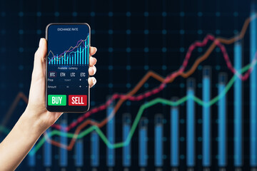Close up of businesswoman hand holding cellphone with glowing forex chart on dark background. Trade, stock and finance concept.
