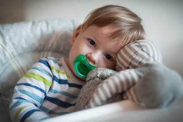 Tender moment between a happy cute baby boy and his favorite stuffed toy. Child concept