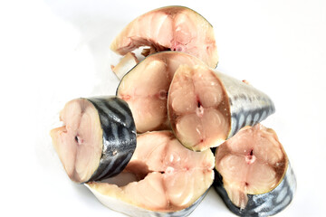 Raw mackerel fish cut into pieces, ready for cooking.