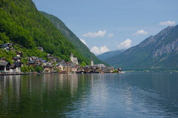 Hallstatt, a charming village on the Hallstattersee lake and a famous tourist attraction, with beautiful mountains surrounding it, in Salzkammergut region, Austria, in summer sunny day.