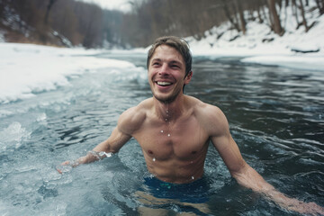 young happy man bathes in winter in a frozen river against the backdrop of a snowy forest