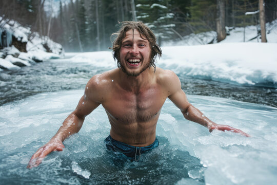 young happy man bathes in winter in a frozen river against the backdrop of a snowy forest