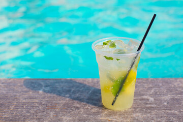 Cocktail glass on turquiose water background