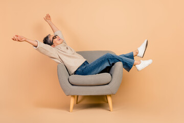 Full body length photo of lying on armchair beautiful grandmother raised arms up after new year...