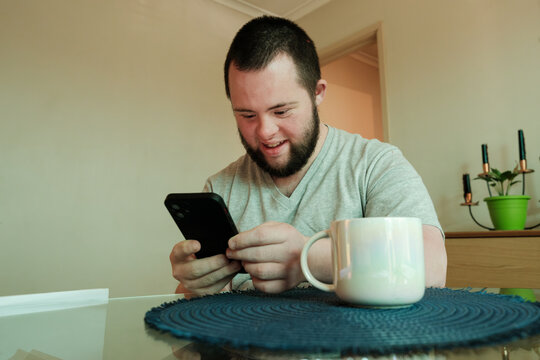 Young Man with Down Syndrome in Video Chat on Smartphone