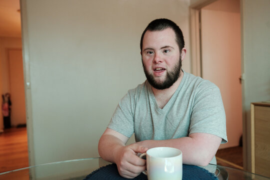 Young Man with Down Syndrome Chatting Over a Cuppa