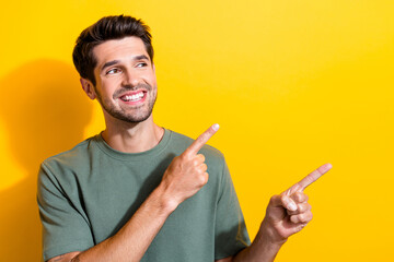 Photo of satisfied man with bristle dressed khaki t-shirt indicating look at promotion empty space...