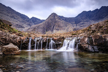 Fototapeta na wymiar Ethereal Beauty of Fairy Pools Under the Majestic Skye Mountains