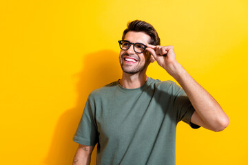 Photo of clever cheerful man dressed khaki t-shirt touch eyewear look at discount empty space...