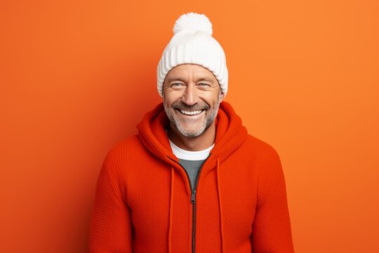Portrait of a cheerful man in his 50s dressed in a warm ski hat against a modern minimalist interior. AI Generation