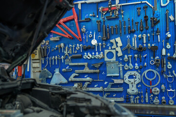 An abundance of mechanic tools neatly hung on the workshop wall, a visual symphony of readiness and precision.