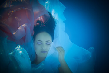 Underwater woman close up portrait in swimming pool