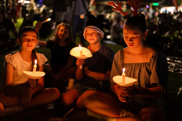 kids holding candles at carols by candlelight