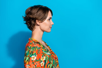 Profile portrait of lovely positive young girl look empty space ad proposition blank isolated on blue color background © deagreez