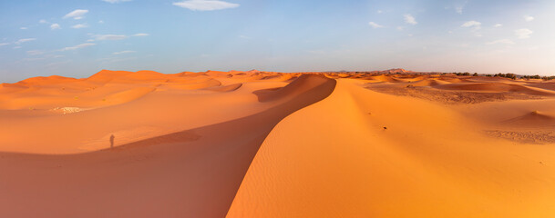 Fototapeta na wymiar Sand dunes in the Sahara Desert at amazing sunrise, Merzouga, Morocco - Orange dunes in the desert of Morocco - Sahara desert, 