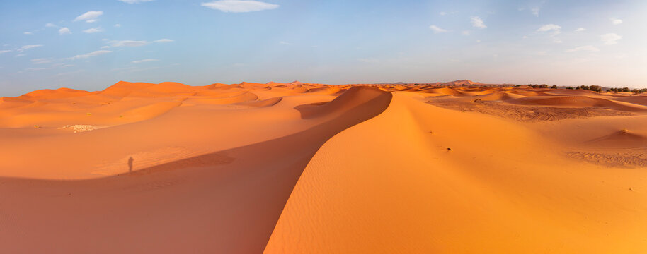 Sand dunes in the Sahara Desert at amazing sunrise, Merzouga, Morocco - Orange dunes in the desert of Morocco - Sahara desert, 