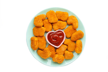Tasty chicken nuggets with ketchup on mint plate isolated on white