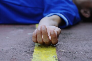 a man lying on the road, accident concept photo, selective focus