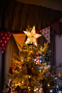 top of a christmas tree with a light up star