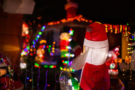 inflatable santa and string lights in a Christmas light display