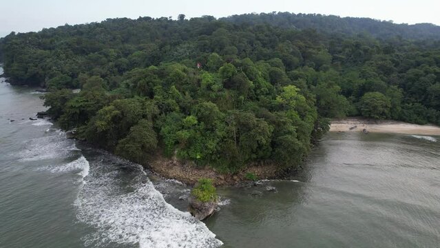 Aerial drone footage of clear, cloudy sky on the beach of Nusakambangan Island (also Nusakambangan or Nusa Kambangan Island) located in Cilacap Regency, Central Java, Indonesia