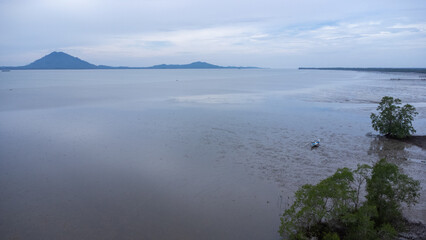 Beautiful view of the receding sea coast area with a mountainous background