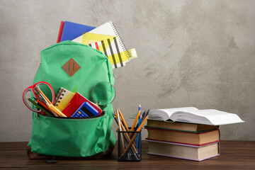 Back to school - books and school backpack on the desk in the auditorium, Education concept.
