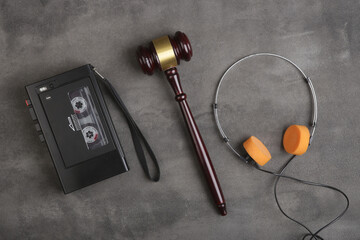 Music piracy and copyright protection law concept, gavel, tape recorder and headphones on table