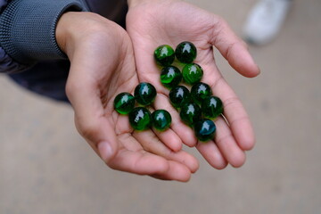 Closeup shot of beautiful marble balls in hands