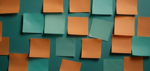  a wall that has many pieces of orange and green paper stuck to it with adhesive adhesive tape on the sides of each of the pieces of the wall.