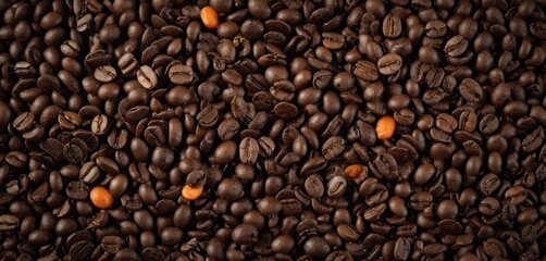  a pile of coffee beans with oranges in the middle of the beans and coffee beans on the bottom of the beans and the bottom of the beans on top of the beans.