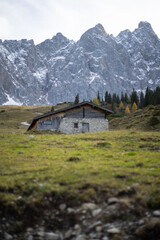 Fototapeta na wymiar A tranquil mountain cabin nestled against a backdrop of majestic, snow-capped peaks.
