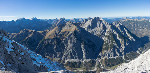 Panoramic view of a majestic mountain range under a clear blue sky