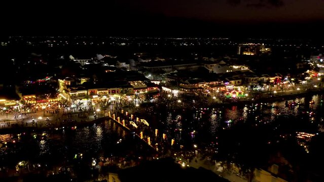 River Boats in Hoi An Old Town at Night.  Vietnam.  4k Aerial Drone Footage