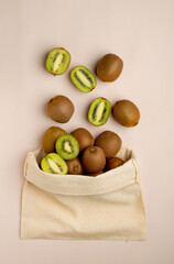 Cotton bag, shopper, with fresh kiwis. The concept of proper nutrition. View from above, close.
