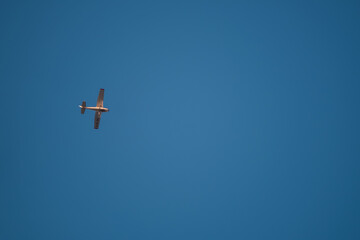 Small plane flying in the blue sky. Single engine Cessna aircraft model