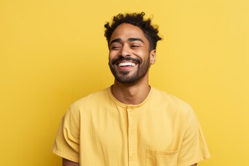 Portrait of a grinning indian man in his 30s donning a trendy cropped top against a pastel yellow background. AI Generation