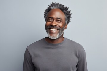 Portrait of a grinning afro-american man in his 40s showing off a thermal merino wool top against a pastel gray background. AI Generation